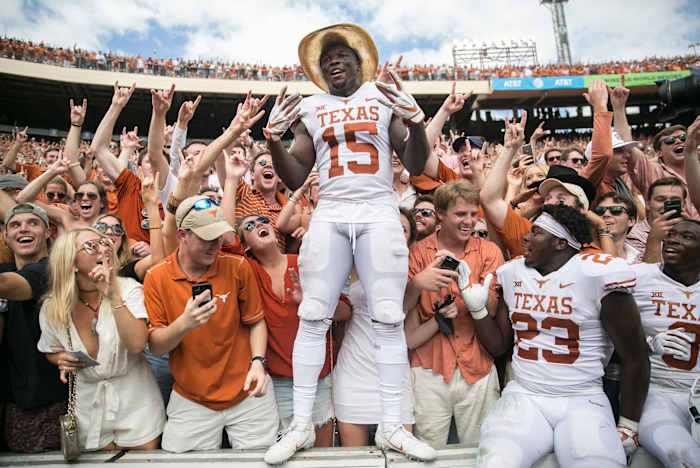 Texas Longhorns defensive back Chris Brown (15) celebrates with fans as he sports the Golden Hat during an NCAA college football game at the Cotton Bowl Stadium in Dallas Texas